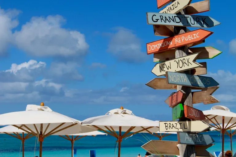  street sign seashore coast seacoast sea-coast sandbar sand bar umbrella-0